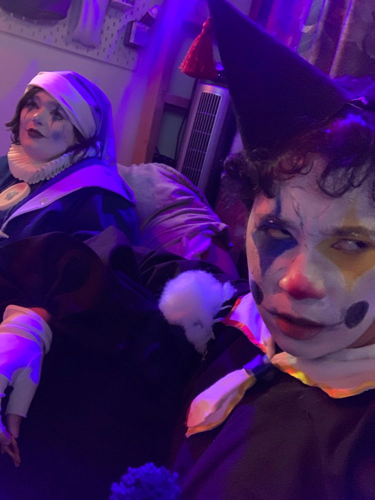 Me and my husband dressed like clowns at a party