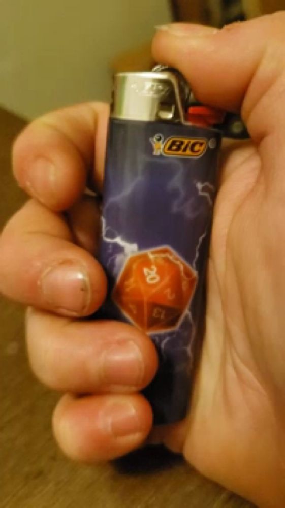 a person is holding a bic lighter with a d20 design on it