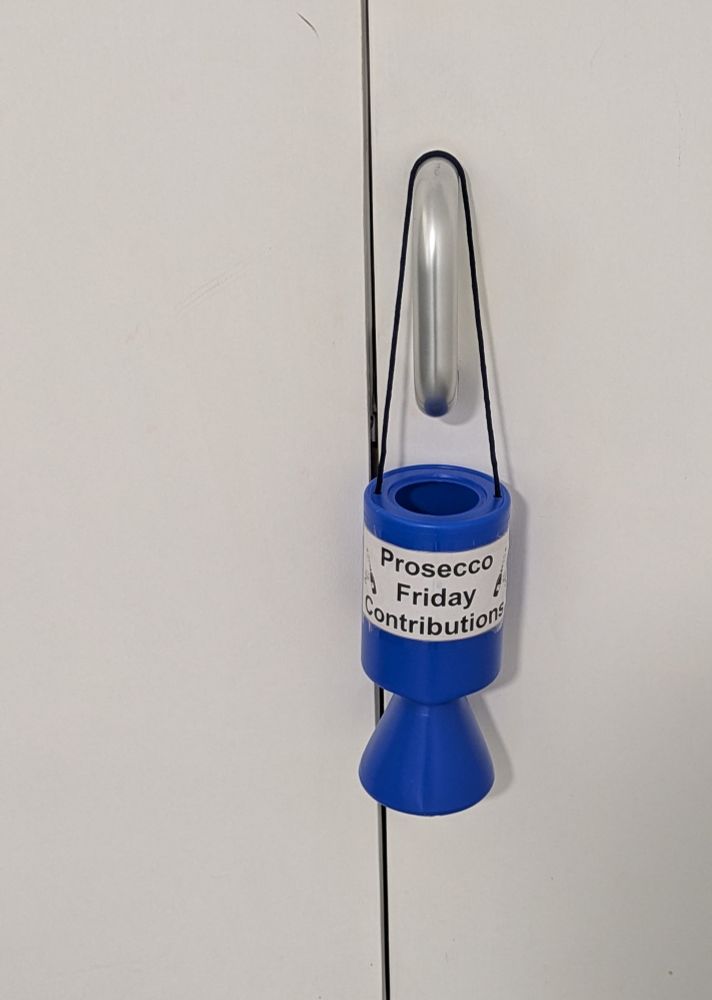 A hanging jar with prosecco Friday contributions written on it 