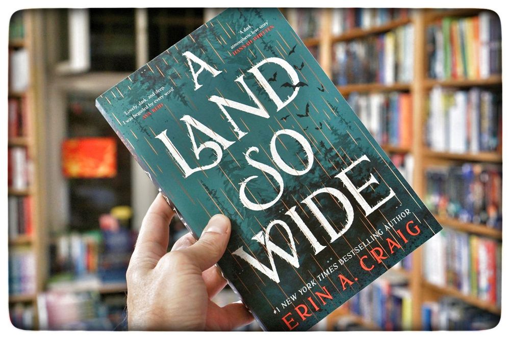 A Land So Wide
by Erin A. Craig

The town of Mistaken has a secret…and it’s up to one woman to uncover the truth, confront her past, and save the man she loves.

Like everyone else in the settlement of Mistaken, Greer Mackenzie is trapped. Founded by an ambitious lumber merchant, the village is blessed with rich natural resources that have made its people prosperous—but at a cost. The same woods that have lined the townsfolks’ pockets harbor dangerous beasts: wolves, bears, and the Bright-Eyeds—monsters beyond description who have rained utter destruction down on nearby settlements. But Mistaken’s founders made a deal with the mysterious Benevolence: the Warding Stones that surround the town will keep the Bright-Eyeds out—and the town’s citizens in. Anyone who spends a night within Mistaken’s borders belongs to it forever.

Greer, a mapmaker and eccentric dreamer, has always ached to explore the world outside, even though she knows she and her longtime love, Ellis Beaufort, will never see it. Until, on the day she and Ellis are meant to finally begin their lives together, Greer watches in horror as her beloved disappears beyond the Warding Stones, pursued by a monstrous creature. Determined to rescue Ellis, she figures out a way to defy Mistaken’s curse and begins a trek through the cold and pitiless wilderness. But there, Greer is hunted, not only by the ruthless Bright-Eyeds but by the secret truths behind Mistaken’s founding and her own origins.

Playfully drawing from Scottish folklore, Erin A. Craig’s adult debut is both a deeply atmospheric and profoundly romantic exploration of freedom versus security: a stunning celebration of one woman's relentless bravery on a quest to reclaim her lost love—and seize her own future.