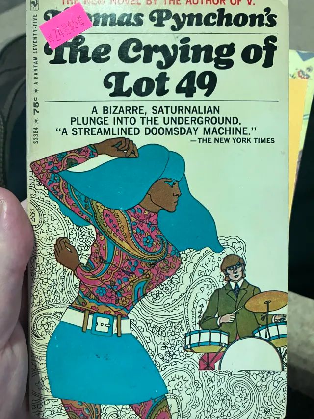 the original paperback edition of The Crying of Lot 49 by Thomas Pynchon. There is a psychadelic dancing woman and a dude playing the drums over a field of like, paisley outlines? Wonderful.