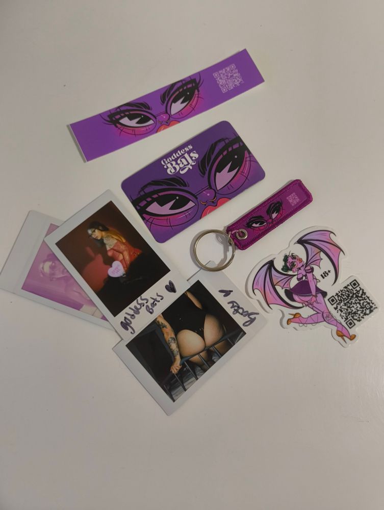 A collection of souvenirs including (counterclockwise from top): a sticker & magnet with cartoon eyes overlayed on a purple background, a keychain with the same morif, a sticker of a cartoon bat character, and three intimate Polaroid photos of the model.