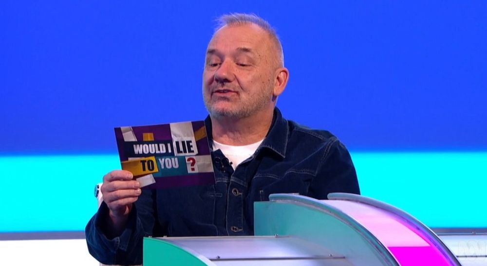 A picture of Bob Mortimer from the british show 'would I lie to you?' where two teams of celebrities tell each other wild stories that they have to guess weather they are telling a lie or the truth