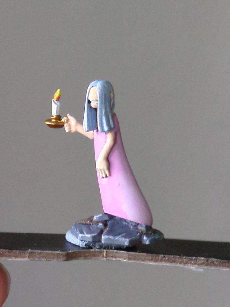 28 mm miniature of a ghost girl with no face holding a candle