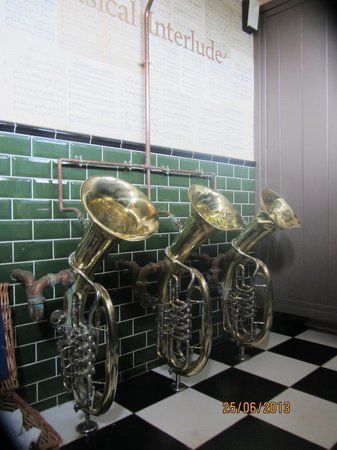 Pub toilet urinals, except they’re genuine brass musical instruments 