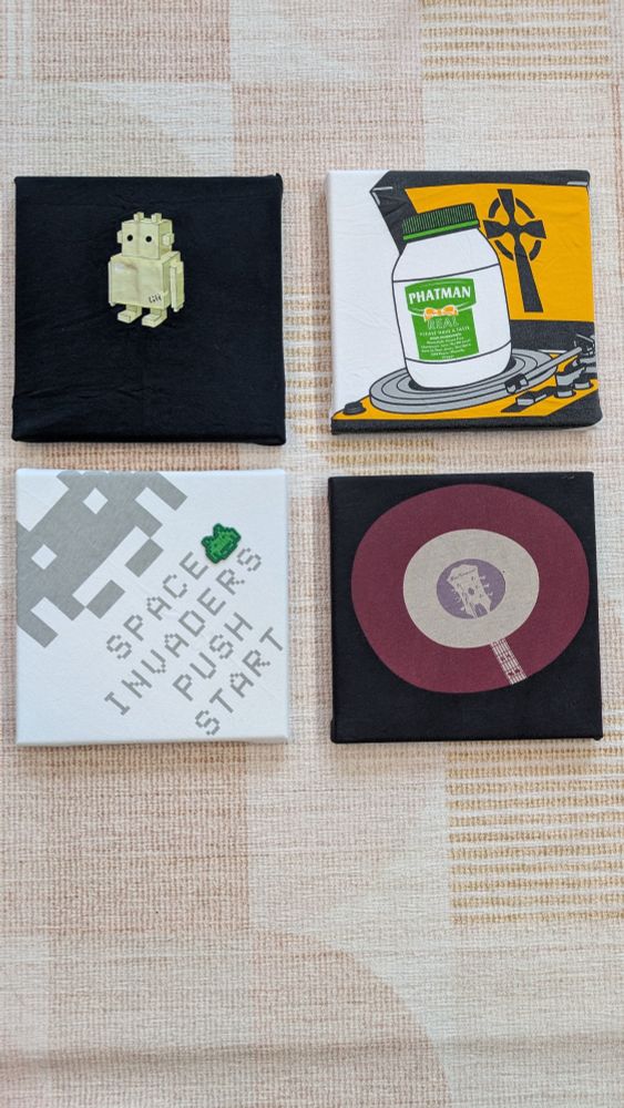 A photo of 8x8 canvases wrapped in tshirts with various designs.