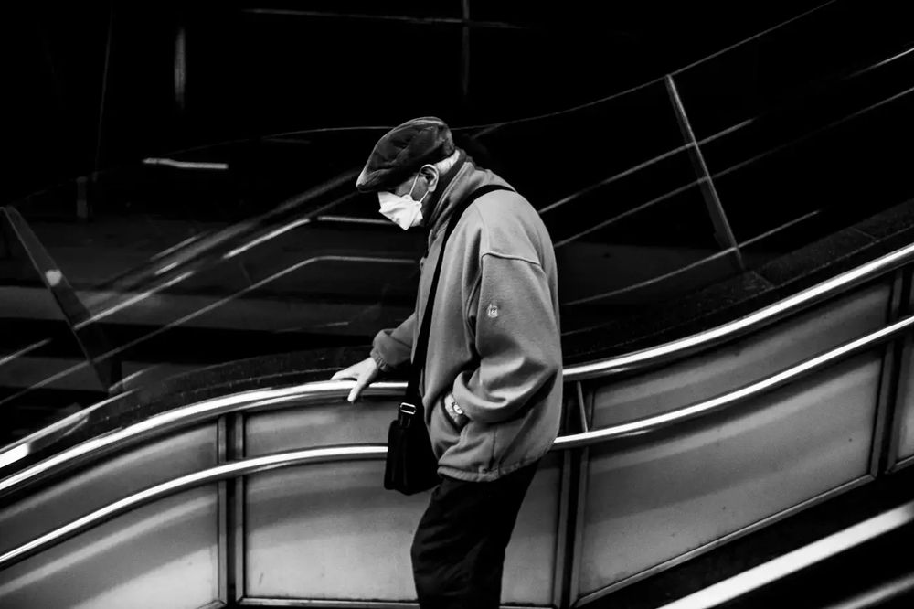 old man walks down the stair of a subway station