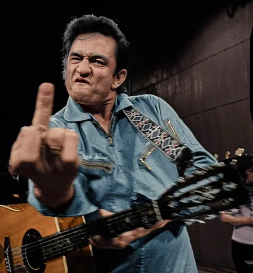 Johnny Cash at his Folsom prison concert giving the middle finger to the camera.