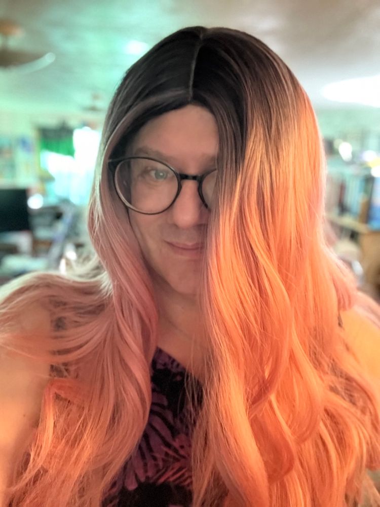 The author with long pink hair hanging down across half her face 
