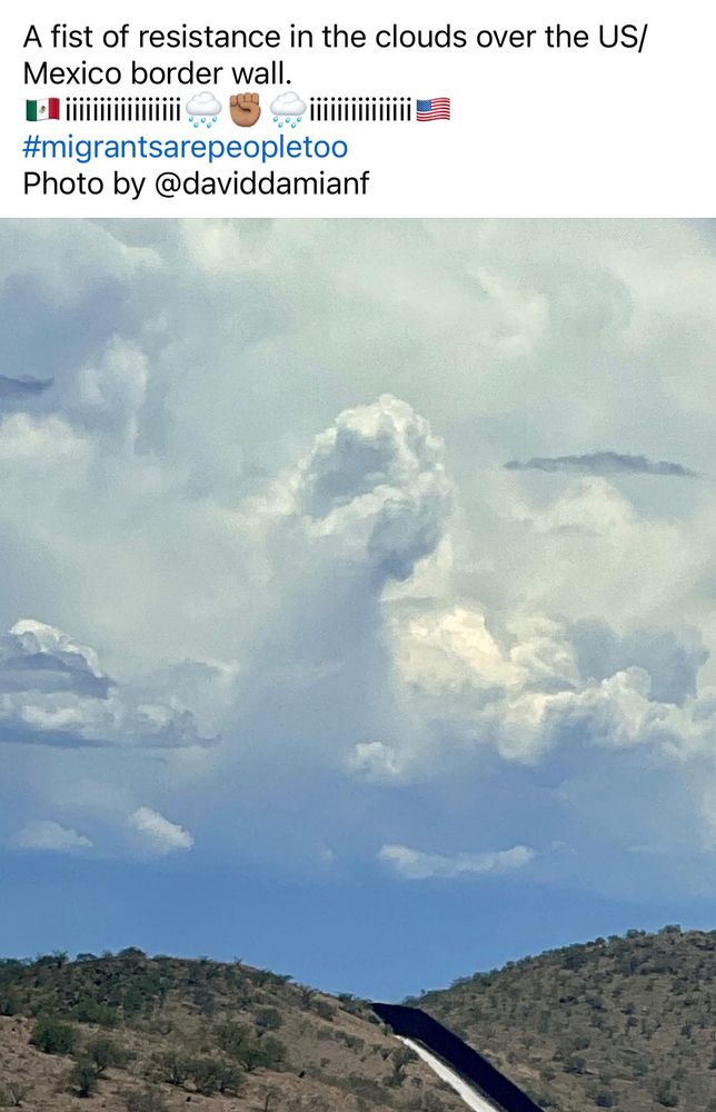 A cloud shaped like a giant fist of resistance over the US - Mexico wall. 