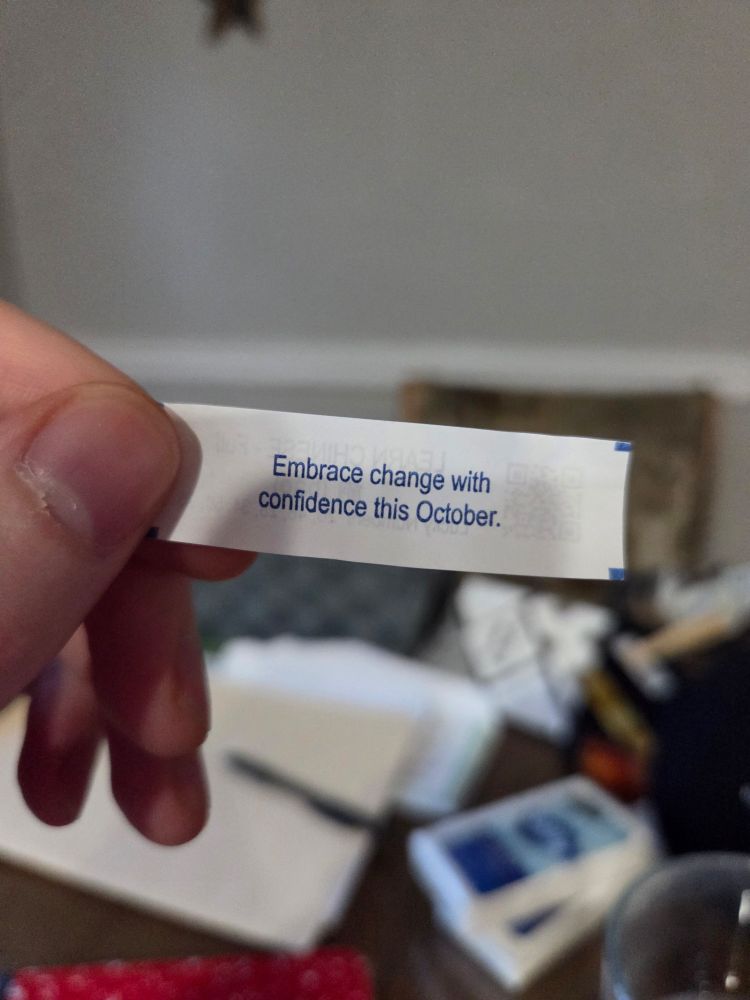 A cookie fortune that reads "Embrace change with confidence this October."