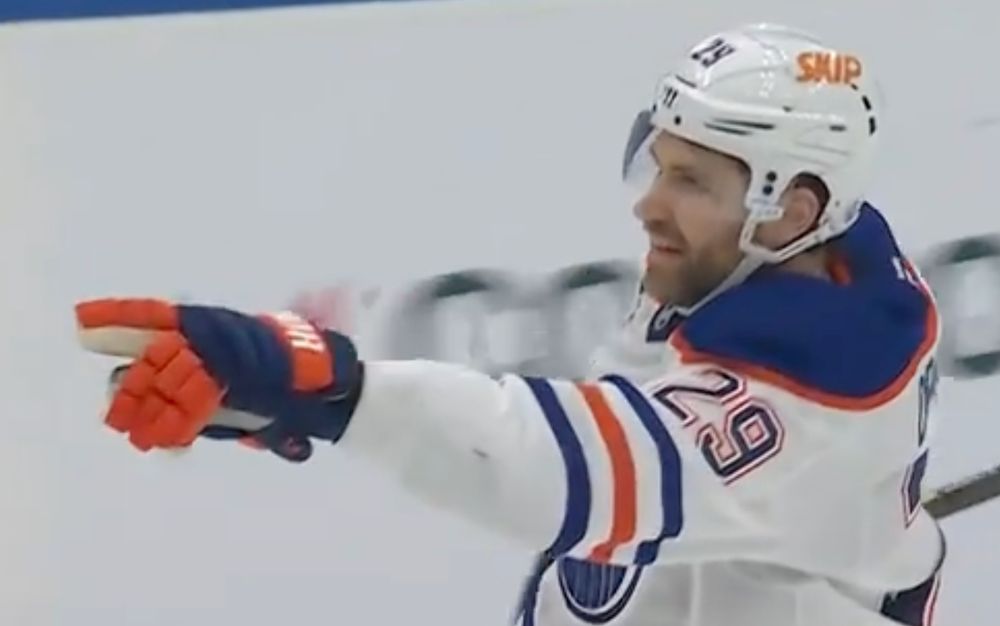 Leon Draisaitl pointing back to Oilers' goalie Calvin Pickard, after scoring an overtime goal on a play launched by Pickard.