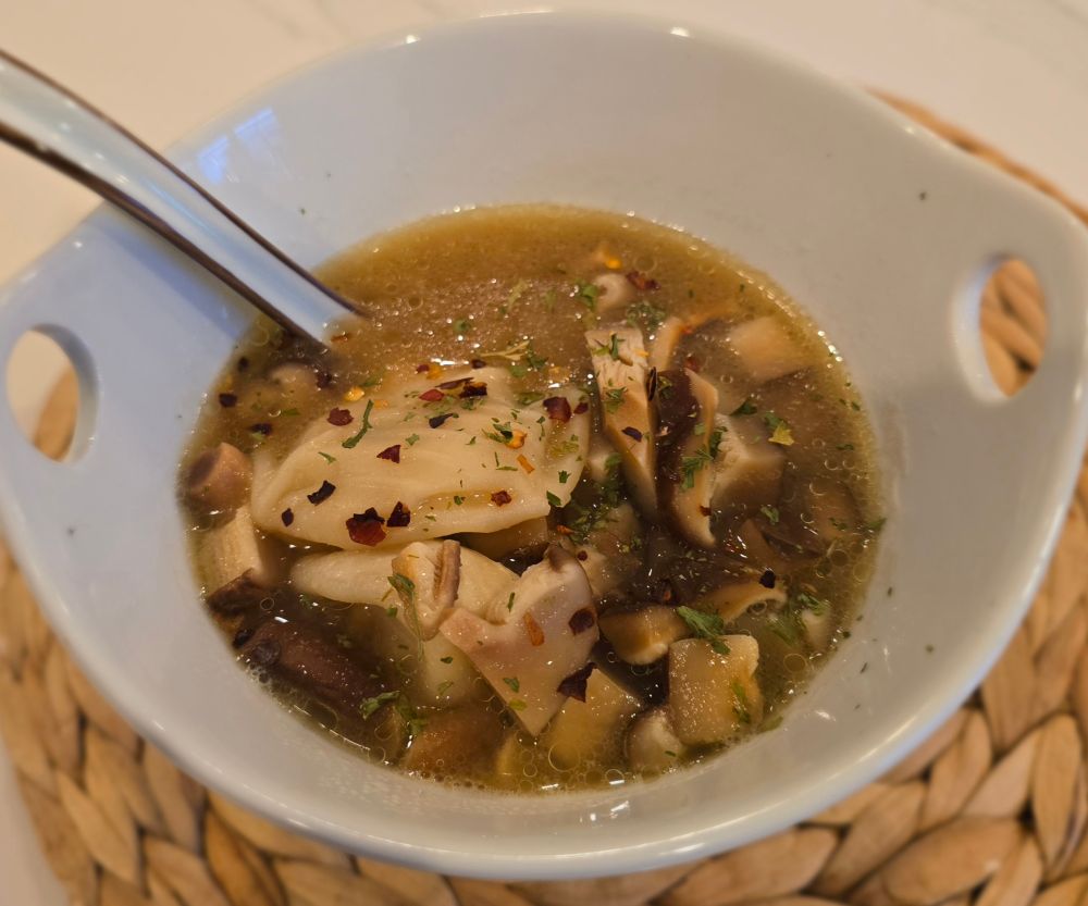 Soup dumplings in miso broth with mushrooms