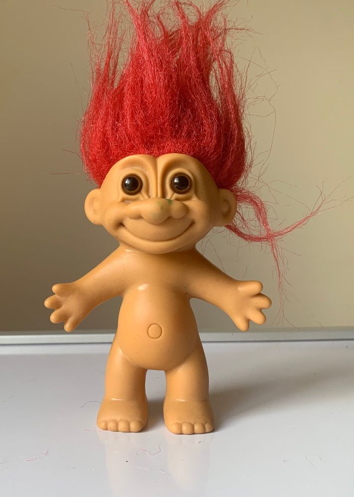 one of those old troll toys naked with big red hair