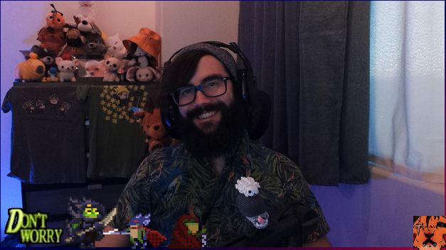 Ian smiling to camera with pupper tower and the meowntain looming behind