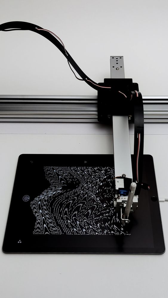 plotter drawing a pattern on a tablet