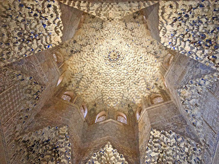 Picture of the ceiling in one of the stunning building of the Alhambra in Granada, Spain. An intriguing example of Islamic architecture, where no being is depicted, but texts of the Quran, mosaics of various geometric shapes in subtle as well as vibrant colours and the most wonderful little courtyards and gardens. A building full of history, bloody at times, but always full of lessons.