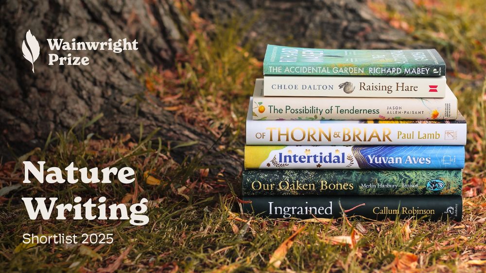 A photograph of a stack of books at the base of a tree, sitting on grass with text to the left-hand side reading 'nature writing shortlist 2025' and the Wainwright Prize logo.
