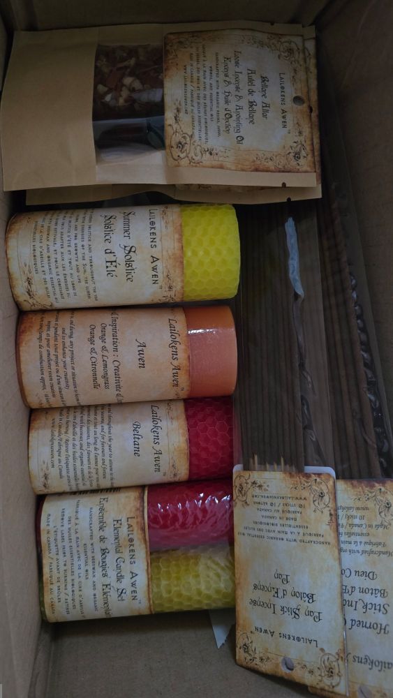 A box containing a variety of incense, beeswax candles, and anointing oil.