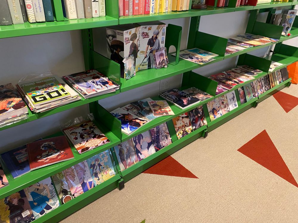 spread of green shelves with yaoi doujin