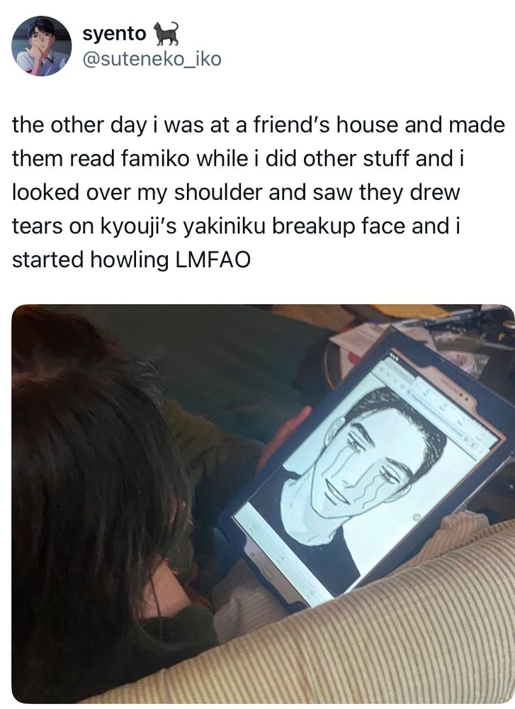 screenshot of a tweet, containing a photo of the OP’s friend holding a tablet in their hand, zoomed in closely on the face of kyouji narita in “famiresu iko” where the friend had drawn squiggly lines below kyouji’s eyes to make it look like he is crying