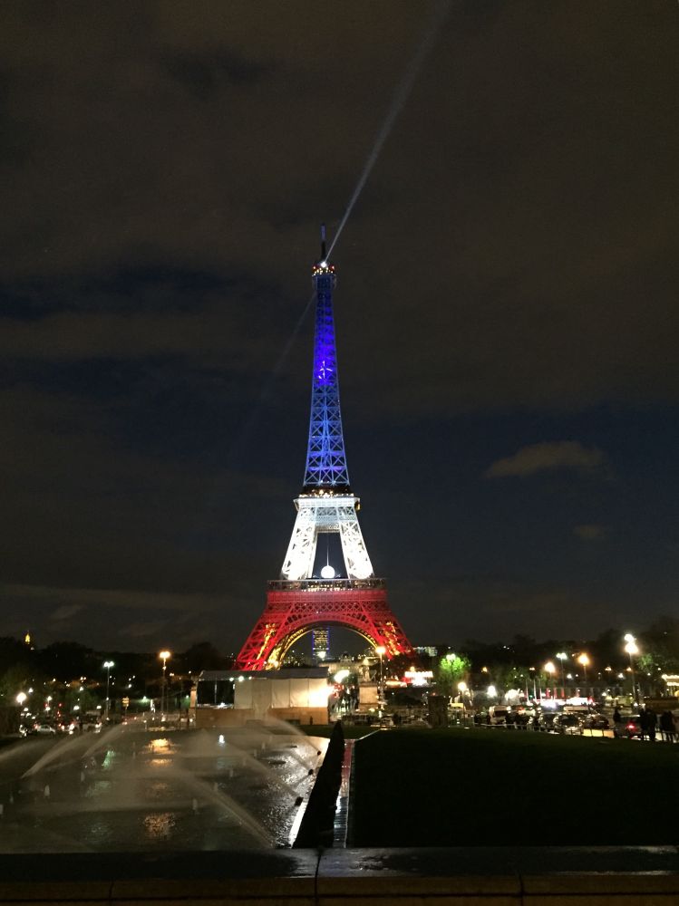 Photo of the Eiffel Tower, lit blue white and red (top to bottom) on the evening of November 25, 2015.  