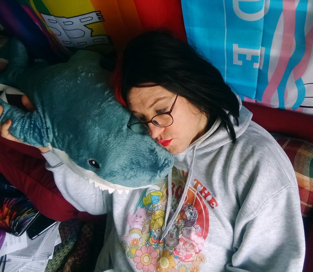 Pretty trans woman cuddling her IKEA blahaj. 