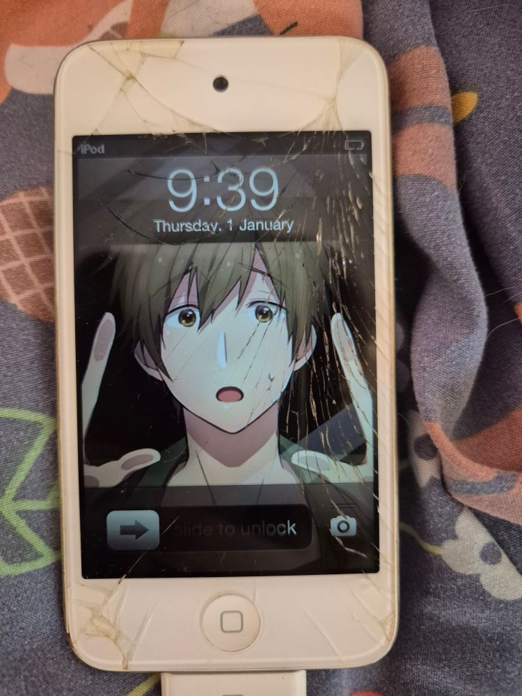 Ipod touch with a heavily cracked screen and a wallpaper image of makoto from free pleading to escape the phone screen