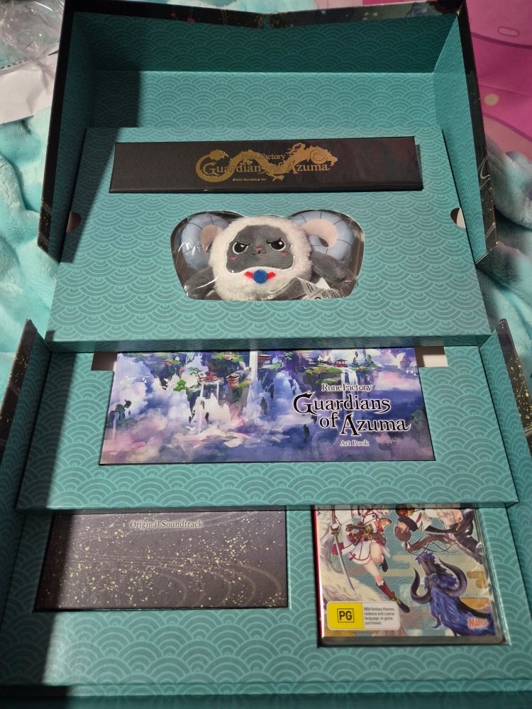 Rune factory guardians of azuma special edition open box. It has 3 layers of merchandise stacked with a cyan background