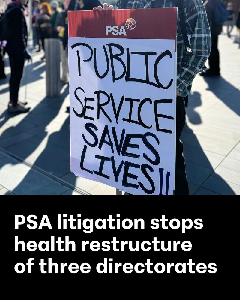 The image is a photograph of a person at a rally holding up a sign that has "PUBLIC SERVICE SAVES LIVES!!" handwritten across it with a PSA braded band across the top. The bottom third of the image is solid black with "PSA litigation stops health restructure of three directorates" in white text.