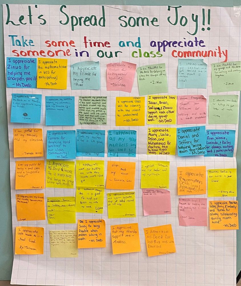 Photograph of a classroom display titled "Let's Spread Some Joy!" Beneath the instructions to appreciate someone in the class community, students have written notes on colorful sticky notes.