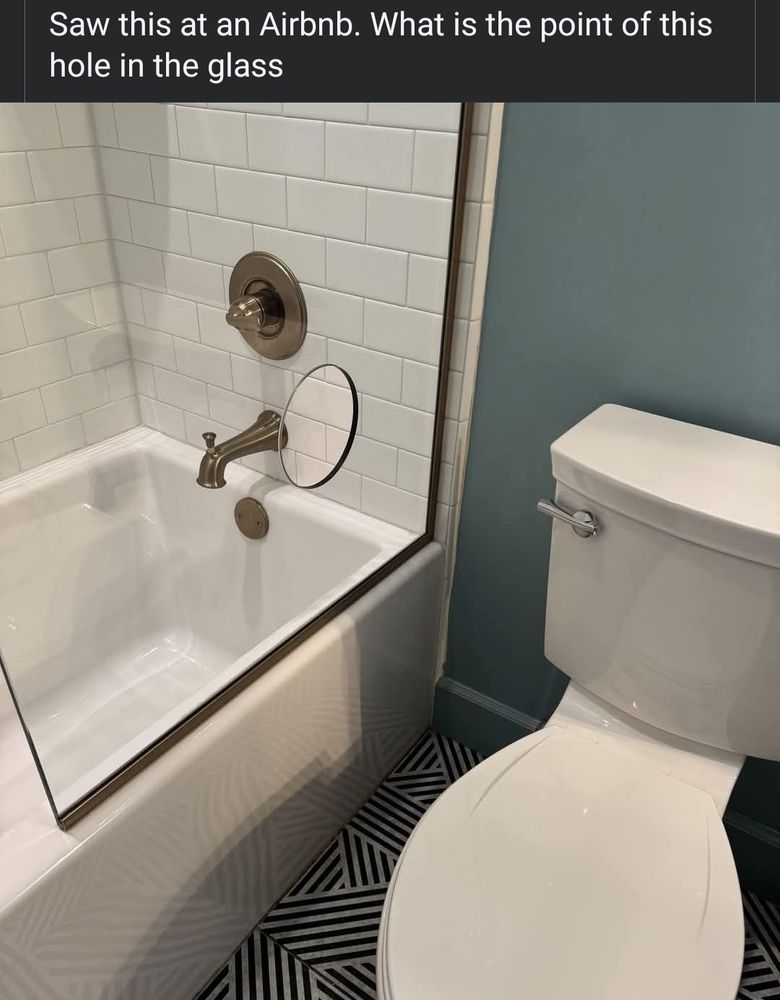 caption: Saw this at an Airbnb. What is the point of this hole in the glass

pictured is a toilet close to the bathtub, with the general shower zone of the tub covered by a sheet of glass. at about the height of the tap to turn it on, is a medium sized hole. (a/n: the implication being its a gloryhole, but the best real explanation is it's to turn the shower on without getting wet)