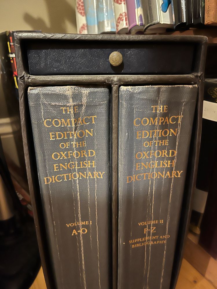 The Oxford English Dictionary. Here in a miniaturised print edition with a magnifying glass in a little drawer built into the case.