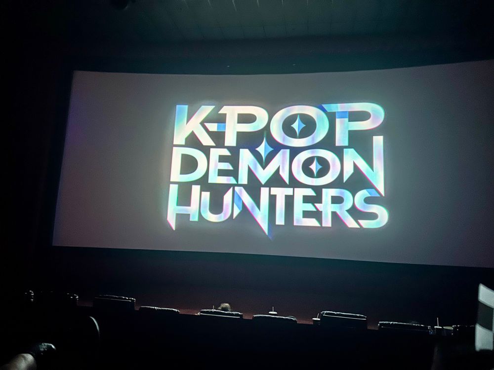 A picture of the title card for Kpop Demon Hunters at the sing along theater event.