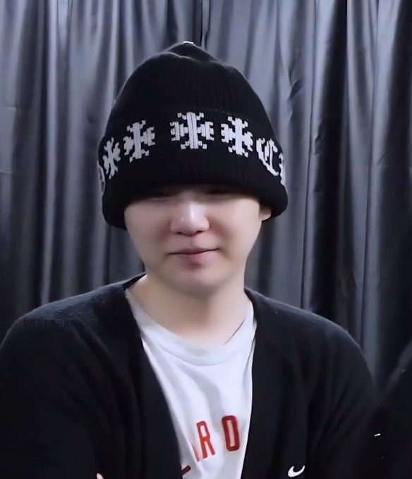Suga of BTS looking like a shy lil dumpling in his tshirt and cardigan and chrome hearts beanie backstage before Hope on the Stage The Final, from the episode released on 7.22.25