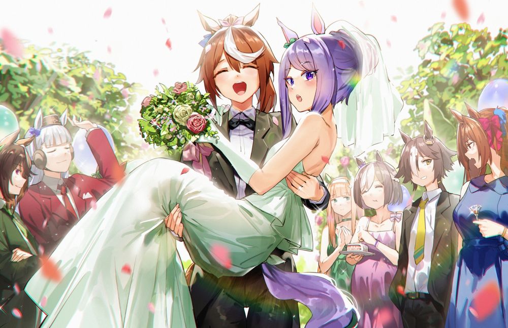 Teio, wearing a tuxeo, is bridal carrying McQueen and smiling, who is wearing a wedding dress. They're surrounded by their friends. 