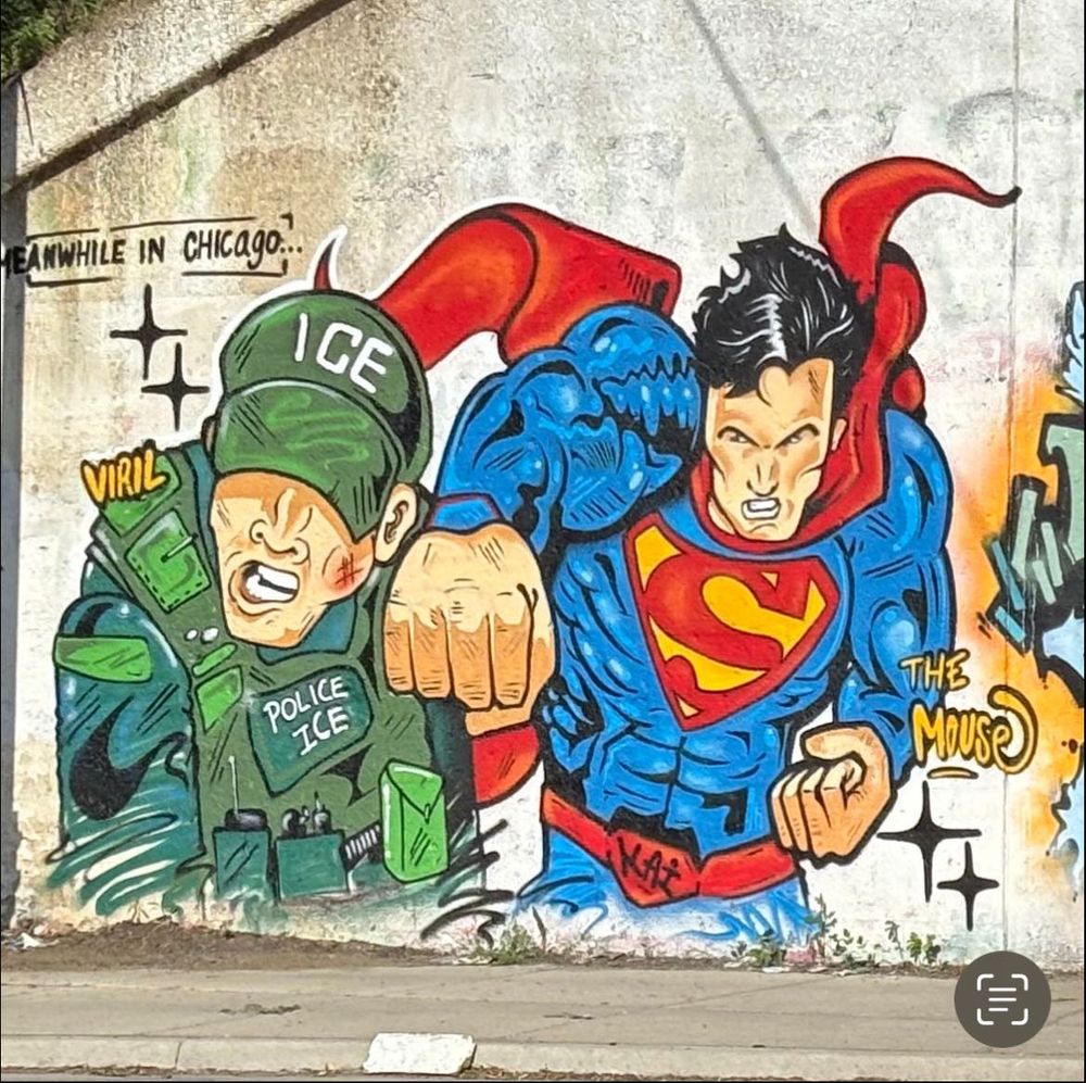 Street art image of Superman punching a uniformed ICE officer