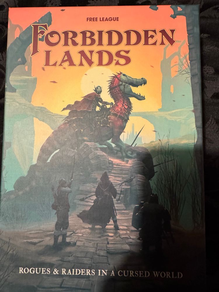 Forbidden Lands ttrpg box set
3 adventurers face a knight riding a lizard thing