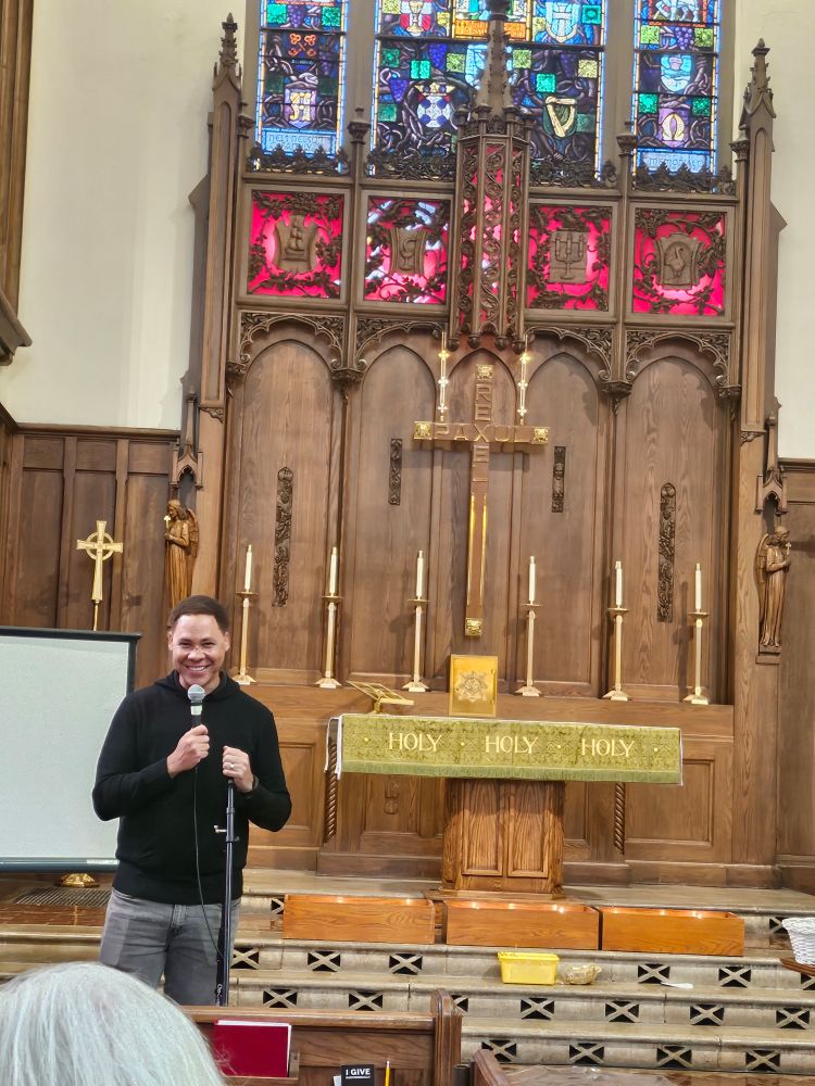 Alder Matt Martin addressing the crowd from the front of the Luther Memorial Sanctuary