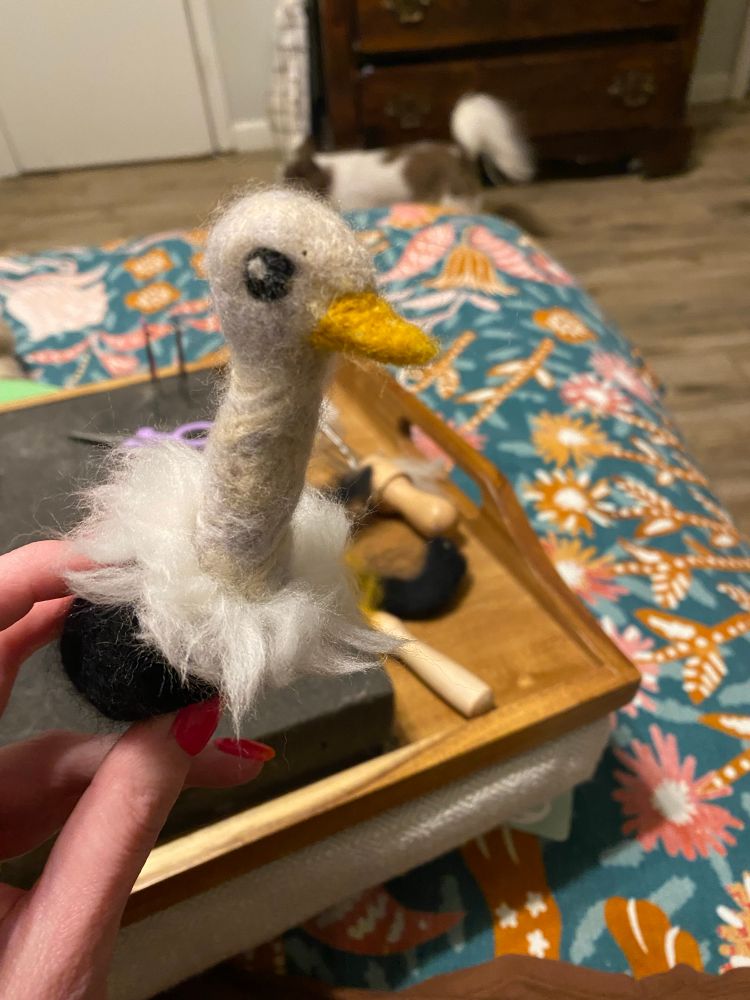 The form now has a larger, black body, eyes, a beak, and a ruffle of white neck feathers. He is CUTE. 