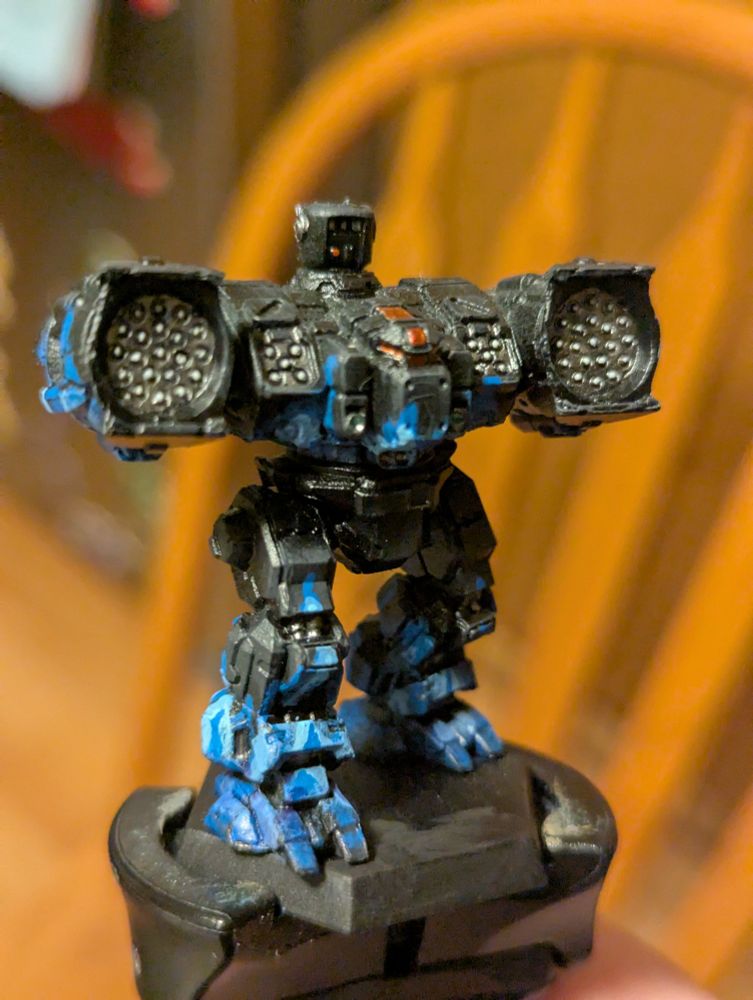 A Longbow BattleMech Mini, painted as the First Kestrel Grenadiers: black with blue flames 