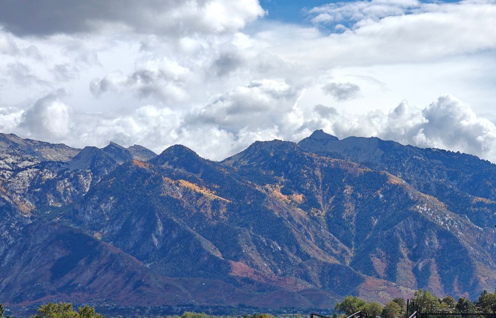 Mountain with autumn leaves stripping through the canyons