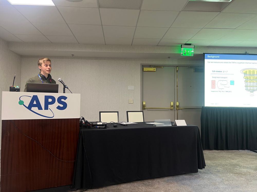 Simon Sundelin speaking at a podium at APS 