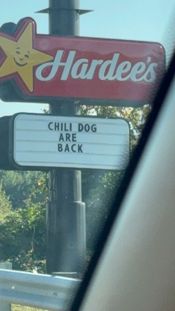 A billboard for a Hardee's restaurant reads:
CHILI DOG
ARE 
BACK