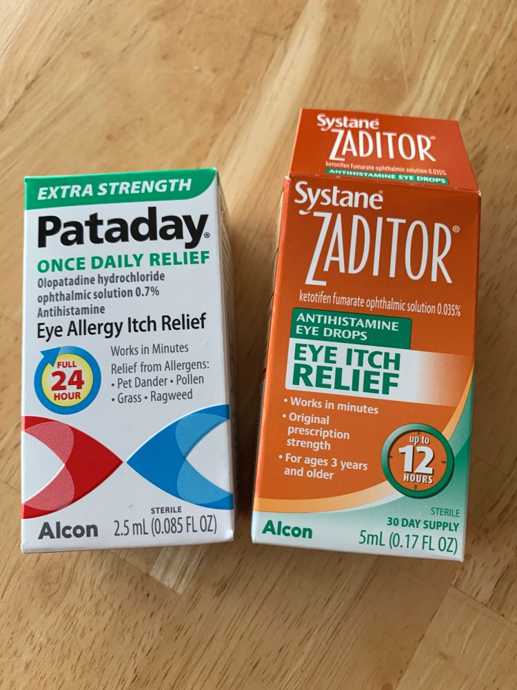 A picture of two boxes of eye drops. On the left is Pataday in a white box with green, red, and blue shapes. On the right is Zaditor in a orange-brown box