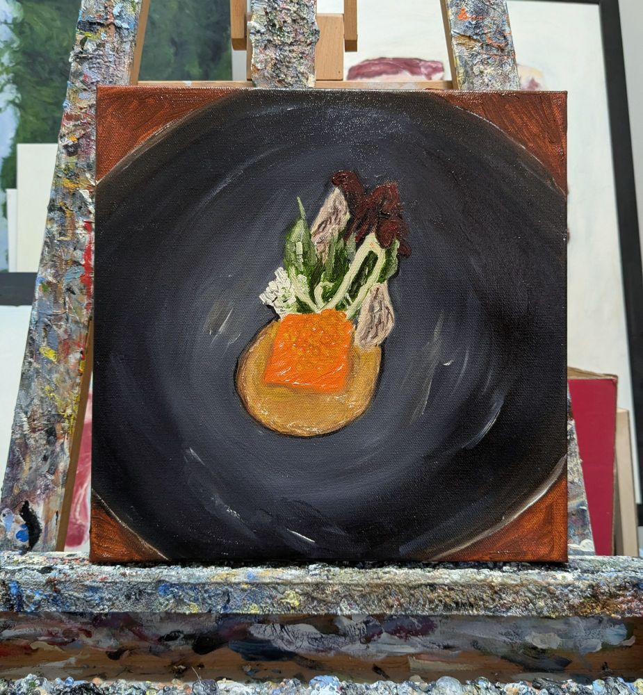 A square canvas painting of a small piece of orange trout with orange trout roe and green basil leaves with a light brown broth in a large black bowl