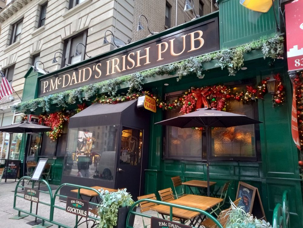A photo of the front of P. McDaid's Irish Pub decorated with garlands and wreaths 