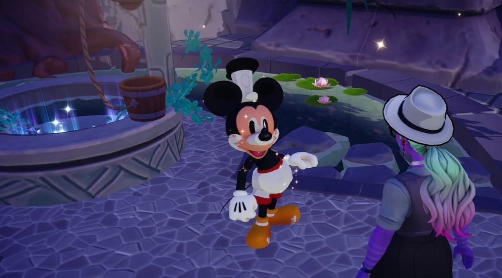 A screenshot from taken from a session of Dreamlight Valley a while ago. Mickey Mouse is standing by a well in the expansion island themed to Atlantis. He’s a mixture of his standard design and his Steamboat Willy design. It’s all fucked up looking. And though the game is notorious for bugs, this was intentional, as it’s part of the Oswald the Lucky Rabbit introduction. Talking to fucked up Mickey is my character, who is dressed in her film noir girl detective best and is also a monster with amazing rainbow hair.