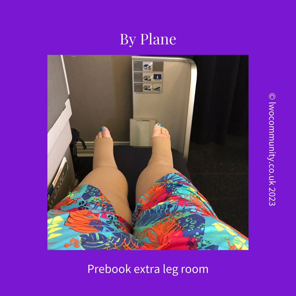 A person is sitting on an airplane with legs stretched out, wearing compression stockings and colorful patterned clothing. The image emphasizes the extra legroom available in the seat. The background includes part of the airplane seat and control panel. The text "By Plane" is at the top, and "Prebook extra leg room" is at the bottom. The website "lwocommunity.co.uk 2023" is on the right side.