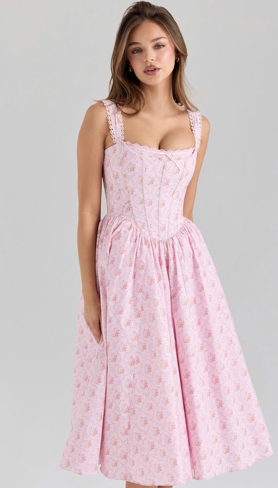 A photo of a model wearing the “Amara Pink Rose Print Stretch Cotton Corset Midi Dress” as listed on the House of CB website, currently priced $285 USD; not my image or my dress, credits to House of CB and their models
